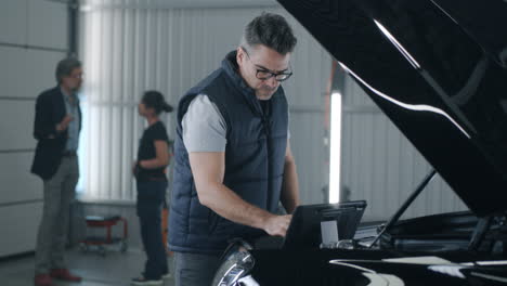 mechanic performing car diagnostics in an auto service center
