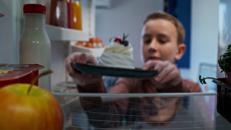 child looking in the fridge for some dessert