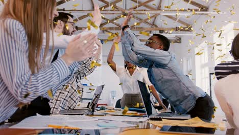 confident african american businesswoman celebrates success with happy young multiethnic team at healthy office meeting.