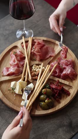 sharing a delicious charcuterie board with wine