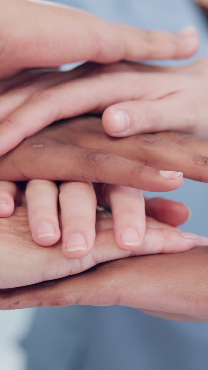 A diverse group of people joining hands in a show of teamwork and unity