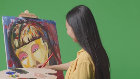 woman viewing abstract portrait painting