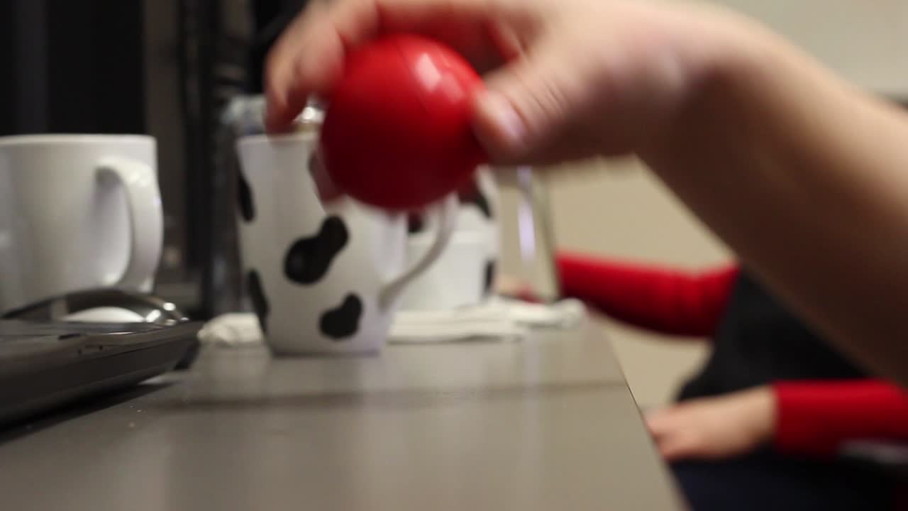 bored employee playing with a ball