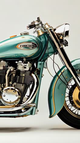 classic turquoise motorcycle parked against a neutral backdrop