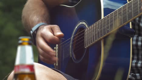 Guy playing the guitar with friends