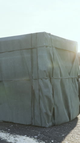 large object covered with tarpaulin