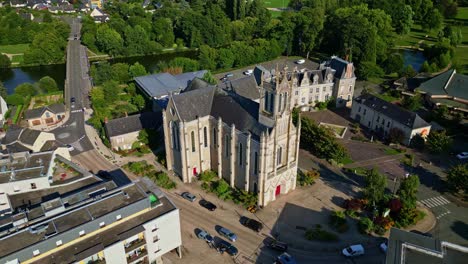 panning drone movement near the historic saint-pierre church of chenillé-changé aka église saint-pierre de chenillé-changé, changé, mayenne, france