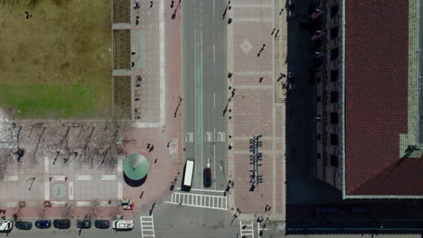 Bird's-eye-shot-of-traffic-on-streets-in-town.-Vehicles-moving-on-road-and-pedestrians-walking-on-pavements-and-crosswalks.-Boston,-USA