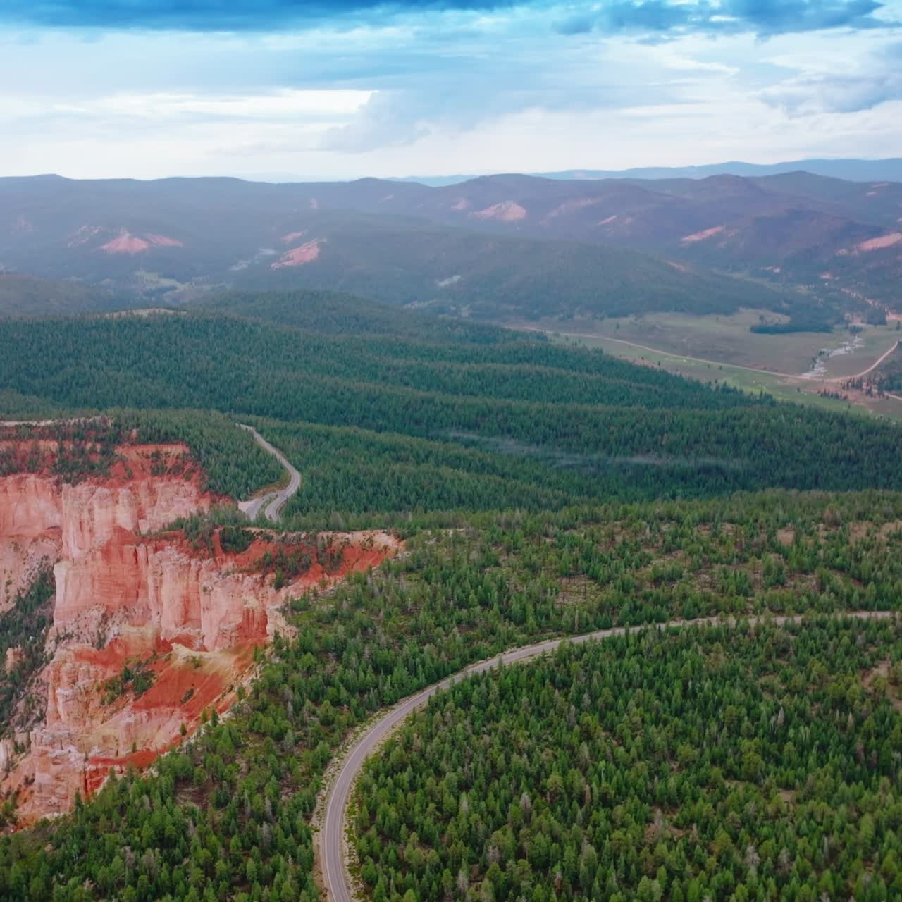 Lovely picture of pine woods covering the mountains in Zion National park, Utah, USA. Road passing through the forest on canyons. Aerial view