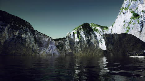 rocky cliffs surrounding calm water under a clear sky at sunset
