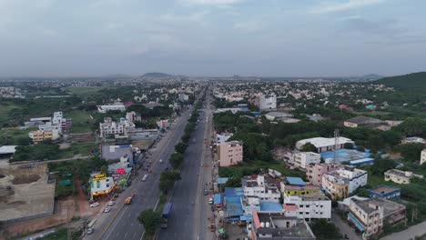 aerial drone shot of highway filled with cars passing through gst road chennai.