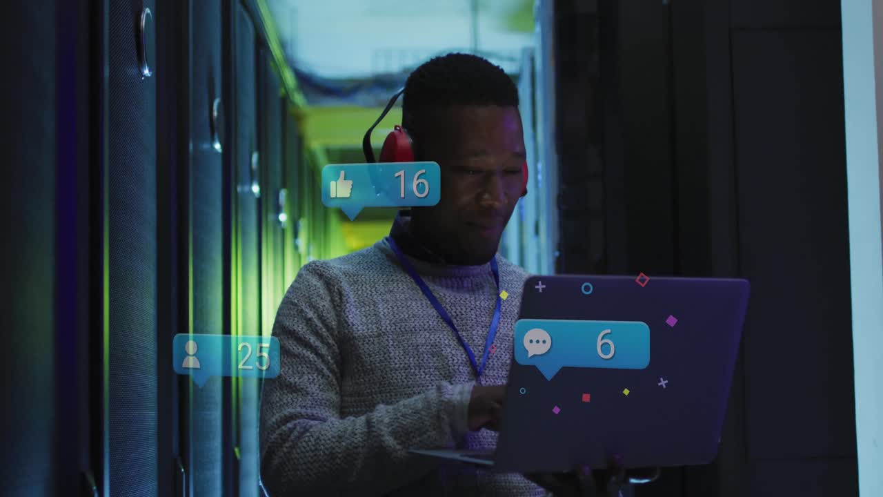 Animation of social media icons over african american male engineer using laptop at server room