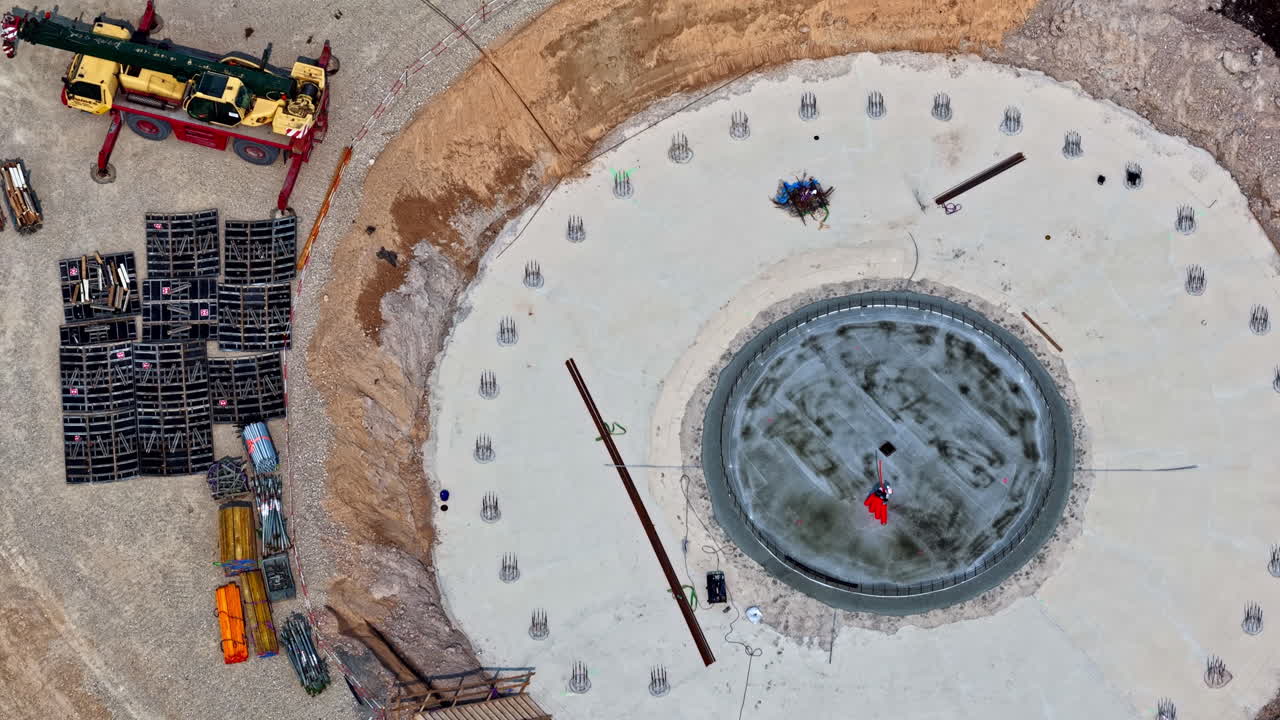 Completed wind turbine foundation with concrete base ready for tower installation