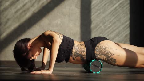 woman doing back stretching with foam roller