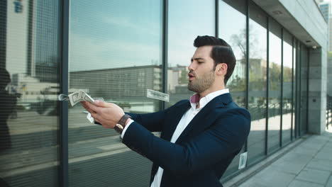 cheerful businessman celebrating victory outside