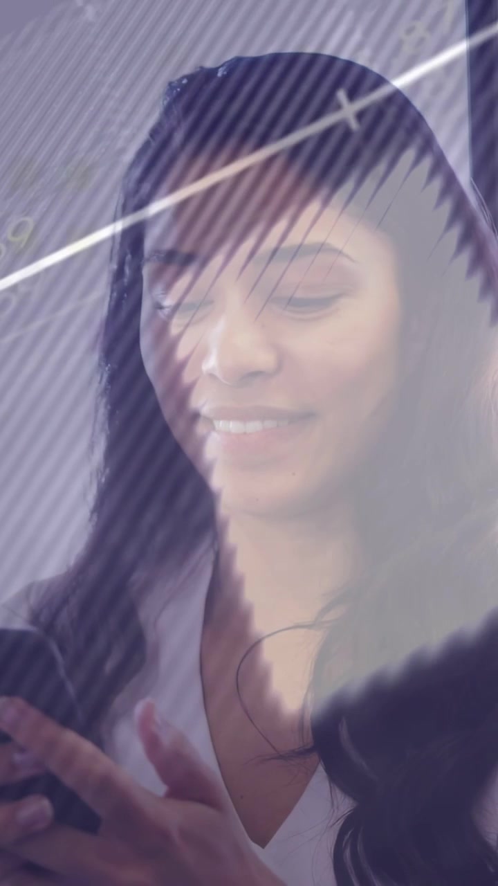 Vertical video: Woman tapping phone, causing graphs over screen for business use