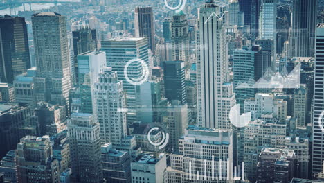 animation of screens with statistical data processing against aerial view of tall buildings
