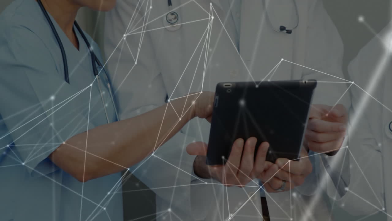 Healthcare professionals collaborating on tablet in hospital, displaying animated network overlay