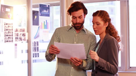 business executives discussing over document