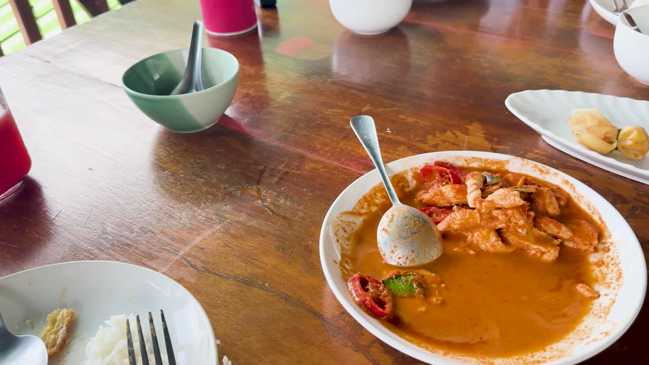 A sequence of frames capturing a meal at a clifftop restaurant in Phuket, Thailand, featuring vibrant dishes and a relaxed atmosphere