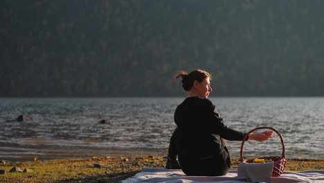 woman enjoying a picnic by the lake