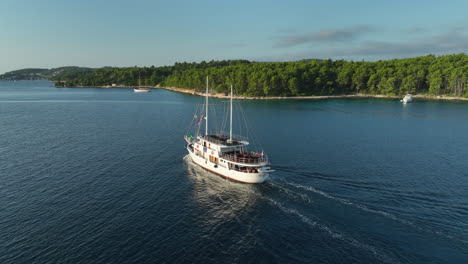 drone following shot of the korcula tour boat during golden hour in croatia