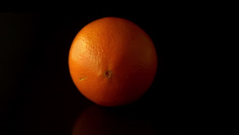 orange spinning on black surface