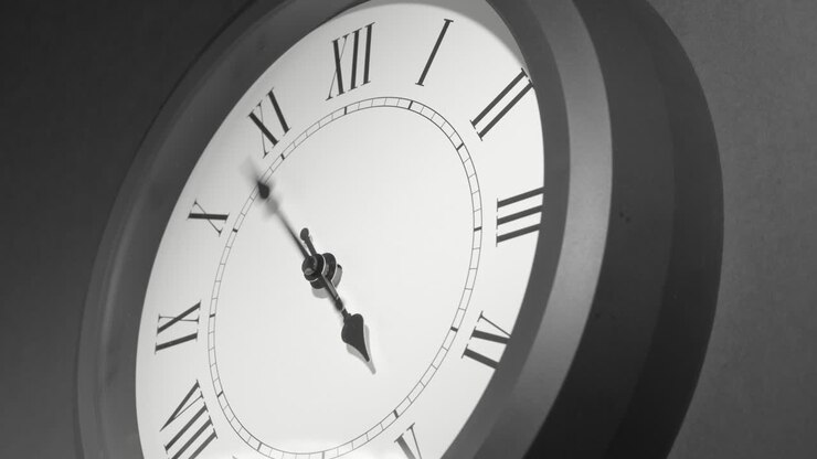 Latin Clock Face in Time Lapse on Dark Grey Wall