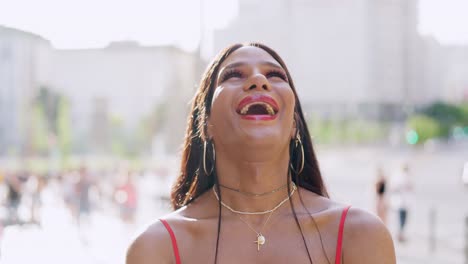 a joyful person smiling and laughing in an urban outdoor setting