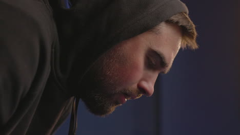 close up of a sweaty sportive man in hoodie having shortness of breath after workout 1