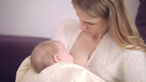 mother feeding baby at home