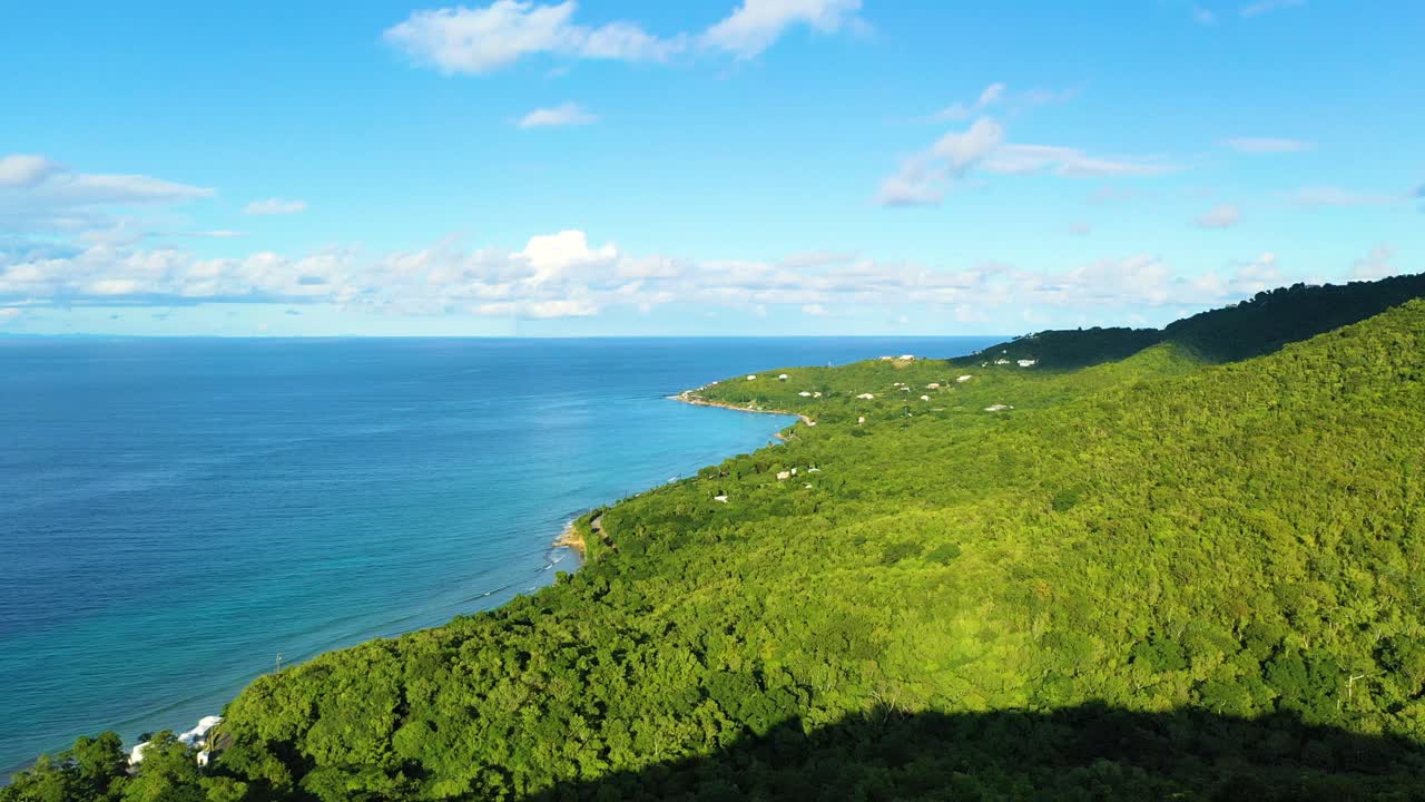 A private Caribbean paradise comes to life near St. Croix, USVI, where crystal waters meet a coastal forest holding just a few upscale vacation villas glowing in the midday sun