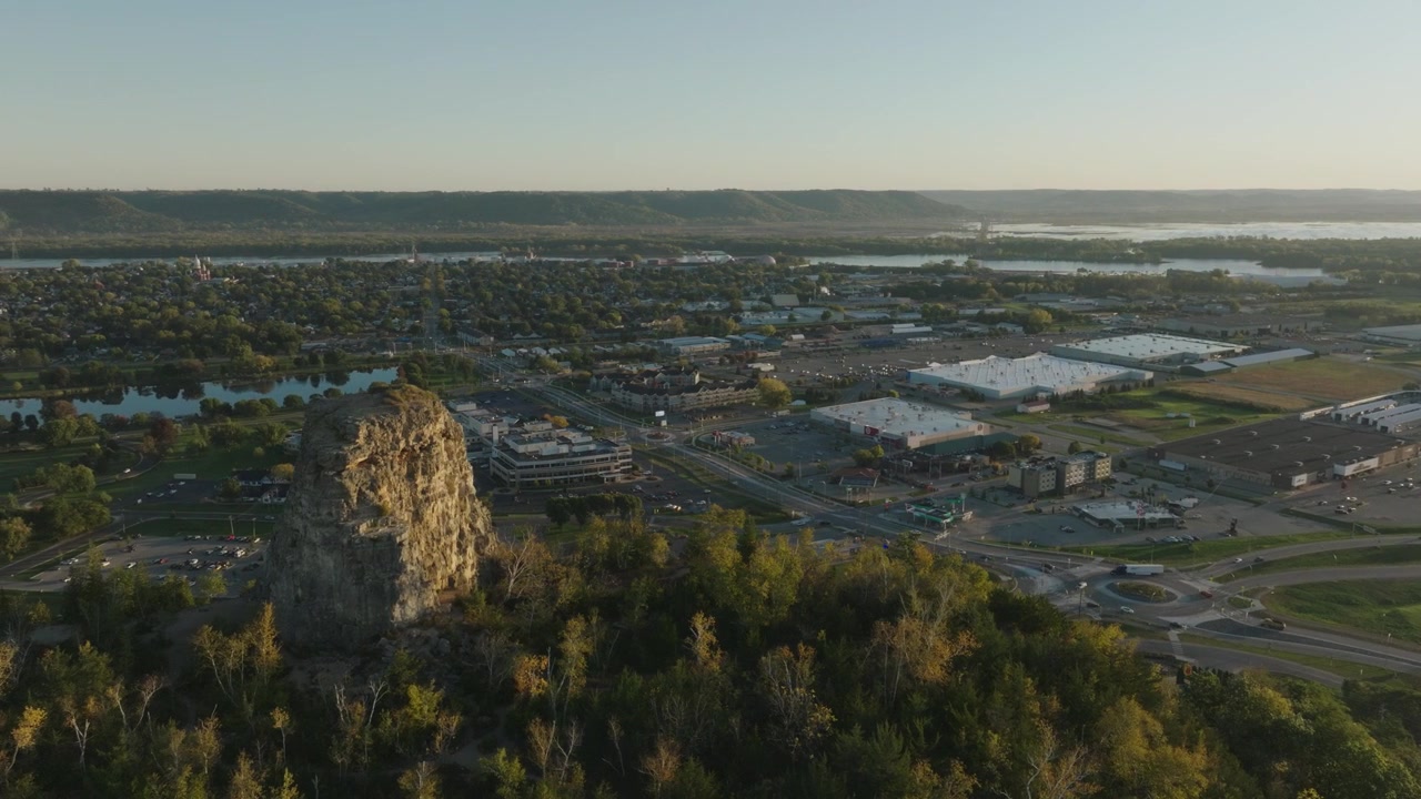 Drone footage capturing a breathtaking aerial perspective of Sugar Loaf Bluff in Winona, Minnesota, showcasing its natural beauty.