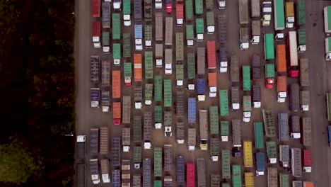 aerial top view of colorful cargo trucks in lot