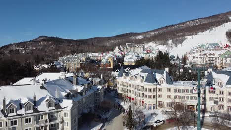 drone approaching ski resort town of mont-tremblant in the canadian province québec, set within the laurentian mountains, aerial footage