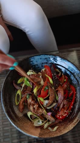woman eating a stir-fry