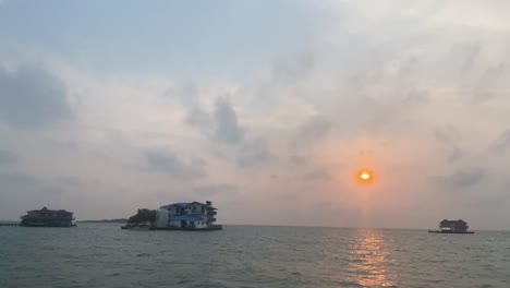 Sunset-over-the-water-with-houses-in-Cartagena,-Colombia