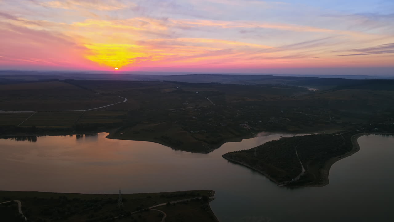Aerial drone view of the Duruitoarea natural reservation at sunset in Moldova. River and village, hills and fields