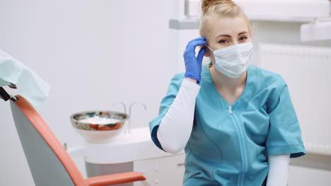 medium shot of exhausted dentist sitting at chair