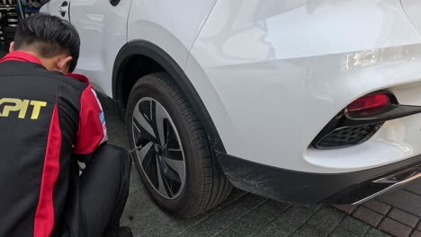 person practicing tire change on stationary car