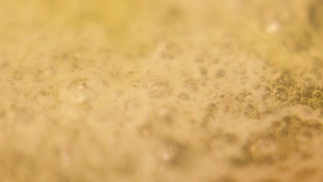 simmer melted butter bubbling gently in pan ready to add meat or vegetables for punchy flavour. macro close up of dairy product