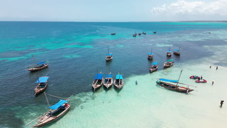 traditional tourist boats moored in clear tropical waters