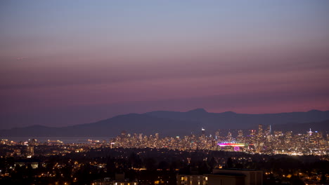 city, ocean and mountains timelapse sunset to evening with fireworks far away zoom shot