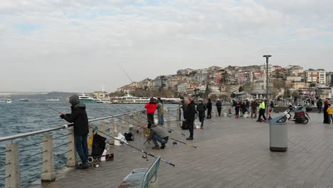 people fishing on istanbul's bosphorus pier