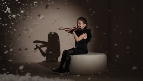 young girl playing violin in a wintery setting