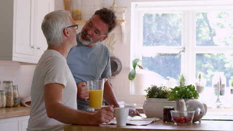 male homosexual couple having breakfast at home together