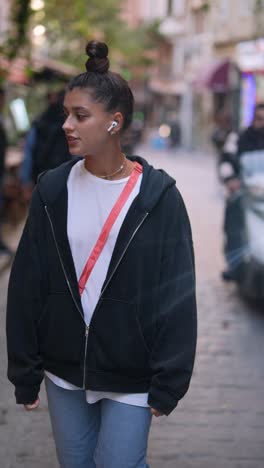 young woman walking in a city street