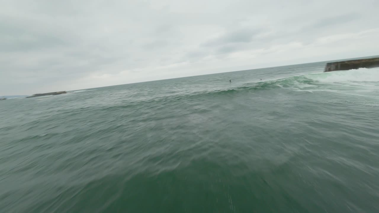 Drone fpv flying over ocean waters of Saint-Jean-de-Luz, Sainte-Barbe, Pyrenees Atlantiques, France