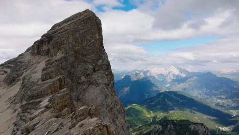 Aerial-orbit-shot-of-Monte-Pelmo-Mountain-in-italian-Dolomites-during-cloudy-day---Green-valley-and-snowy-peak-in-background