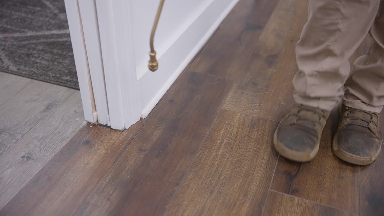 Pest management treatment applied along baseboards in modern office interior, pesticide control